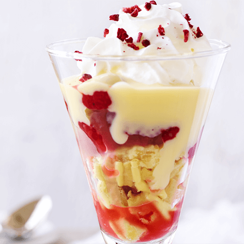 Raspberry and lemon trifle in a sundae glass.